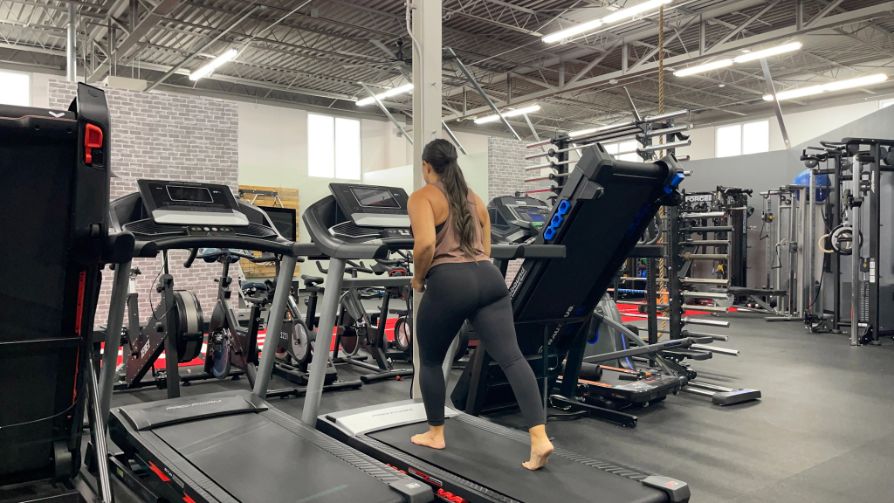 Woman running barefoot on a treadmill