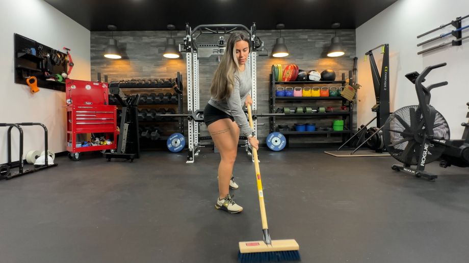 woman sweeping rubber flooring