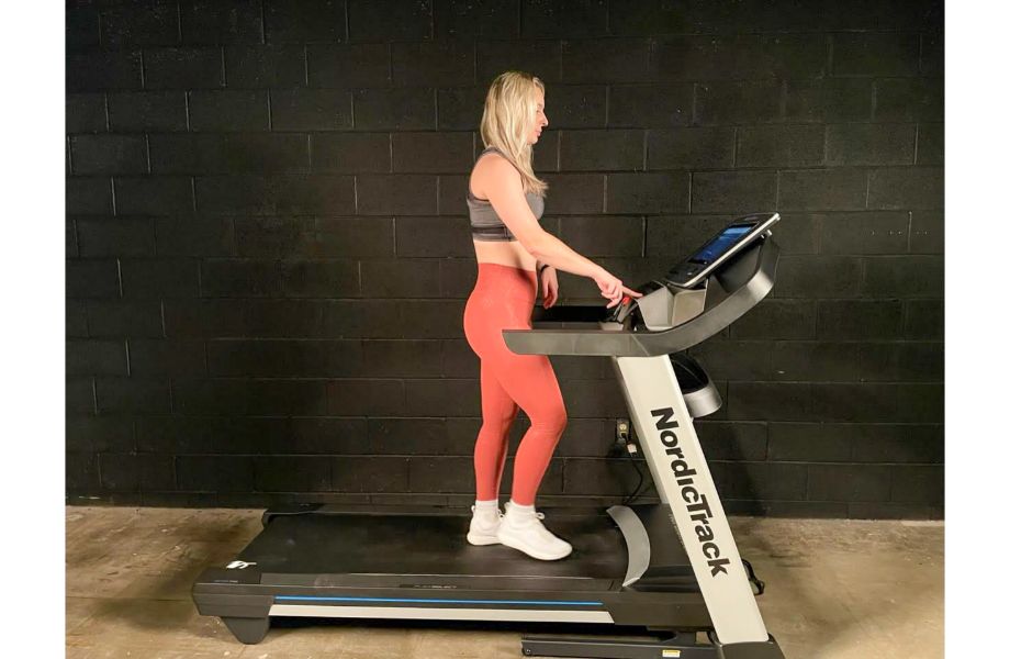 woman using NordicTrack EXP 14i treadmill