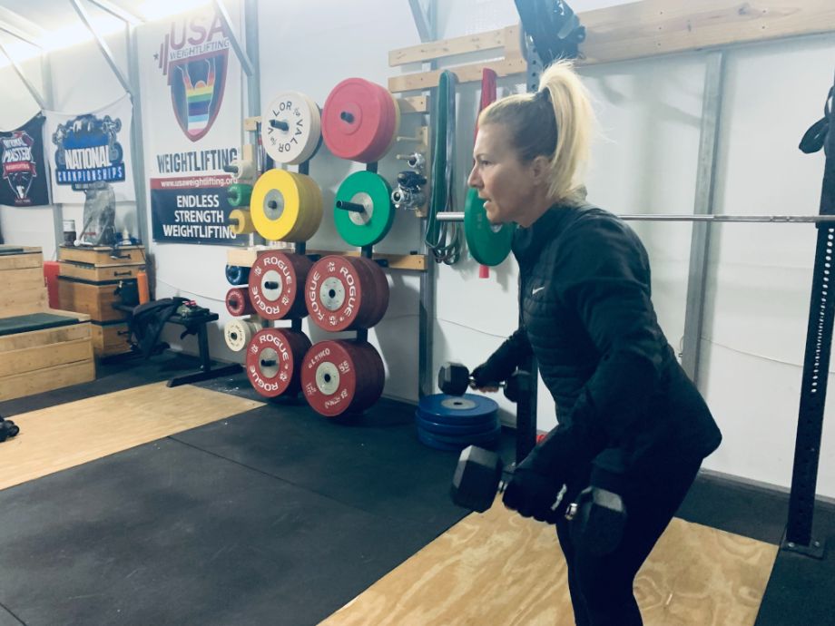 Woman performing dumbbell work with the harbinger weightlifting gloves