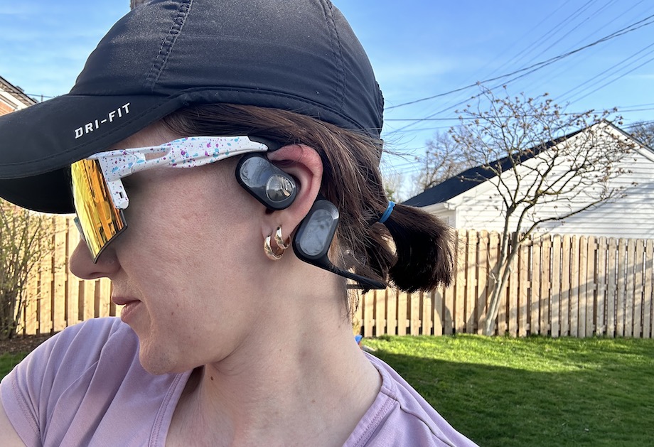 A woman wearing Soundpeats RunFree air conduction headphones