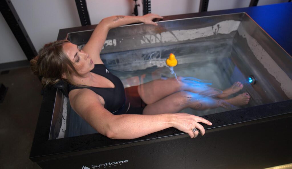 Woman partially submerged in the Sun Home Sauna Cold Plunge Pro 