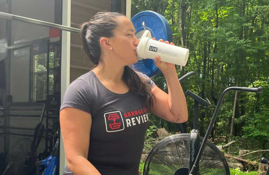 A woman drinks from a shaker bottle