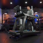 Xebex ST-6000 treadmill set to an incline with man walking normally