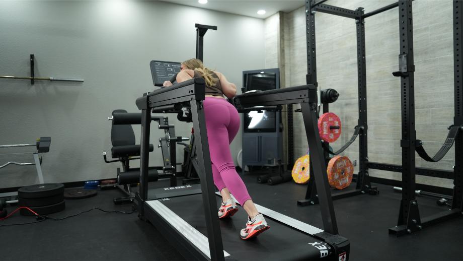 Woman using sled function on Xebex ST-6000 treadmill