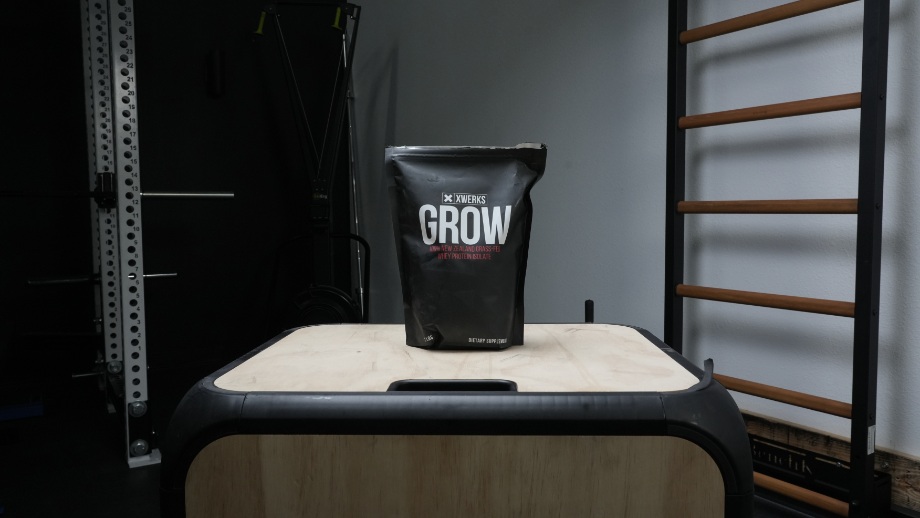 A bag of XWERKS Grow stands proud and lonely in a nice looking gym.